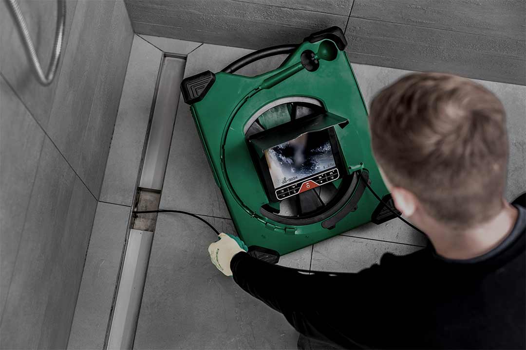 Camtronics Mini Flex 19 inspection camera in use inspecting a shower drain